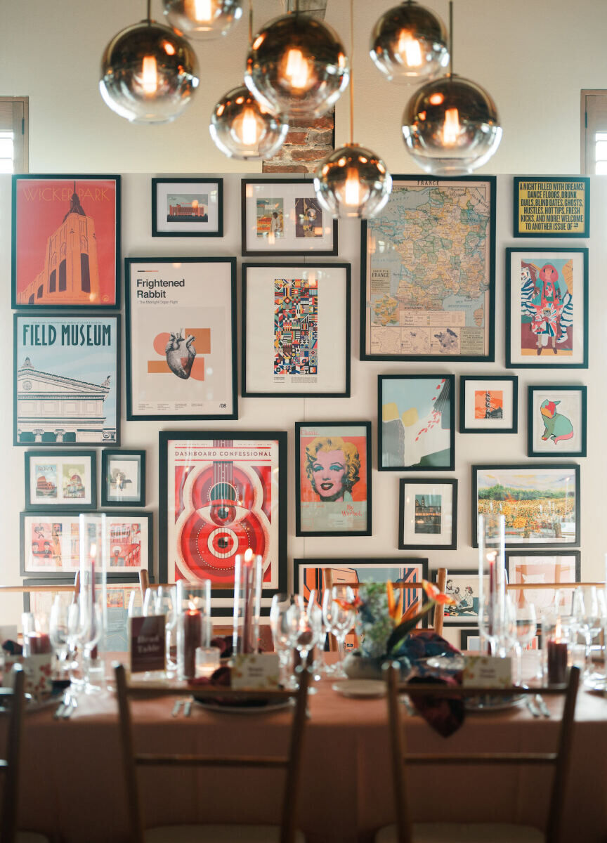 Framed prints formed a gallery wall at an art-inspired wedding reception in Charleston.