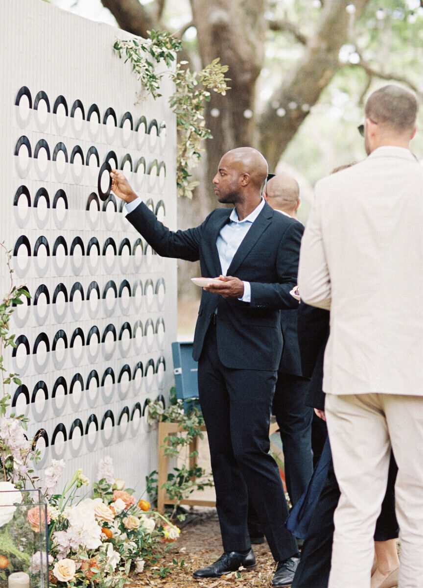 During an elegant spring wedding, guests found their seats thanks to customized vinyl records, which honored the couple's love of music and listening to records at their home.
