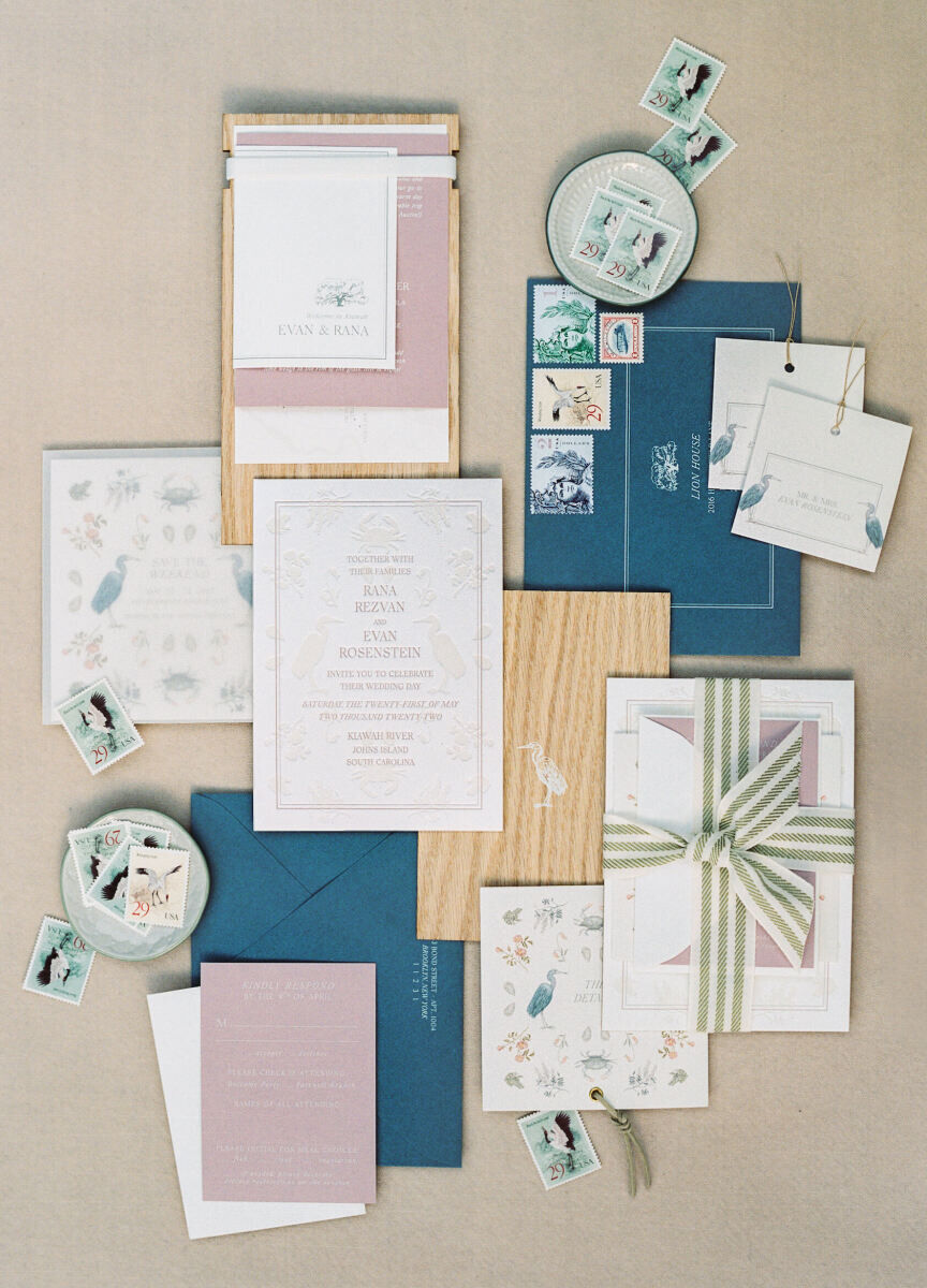 The invitation suite for an elegant spring wedding incorporated custom illustrations, wood elements to hint at the trees at the wedding venue, and a striped ribbon.