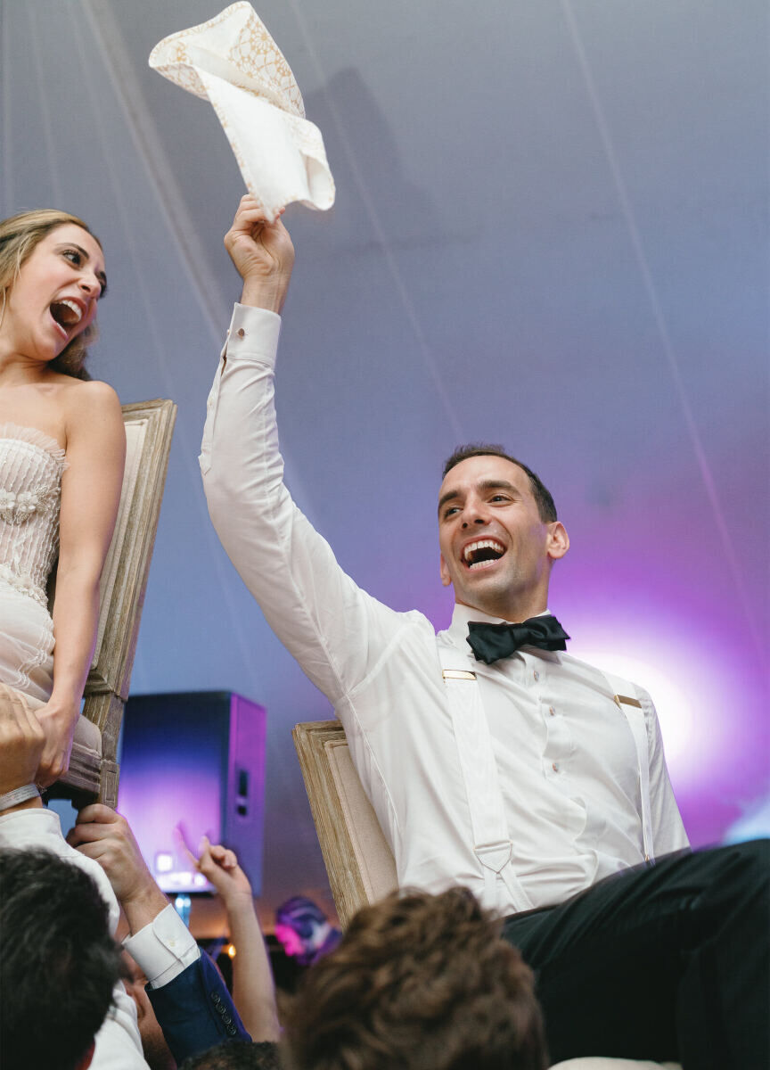 A bride and groom during the hora at their elegant spring wedding.