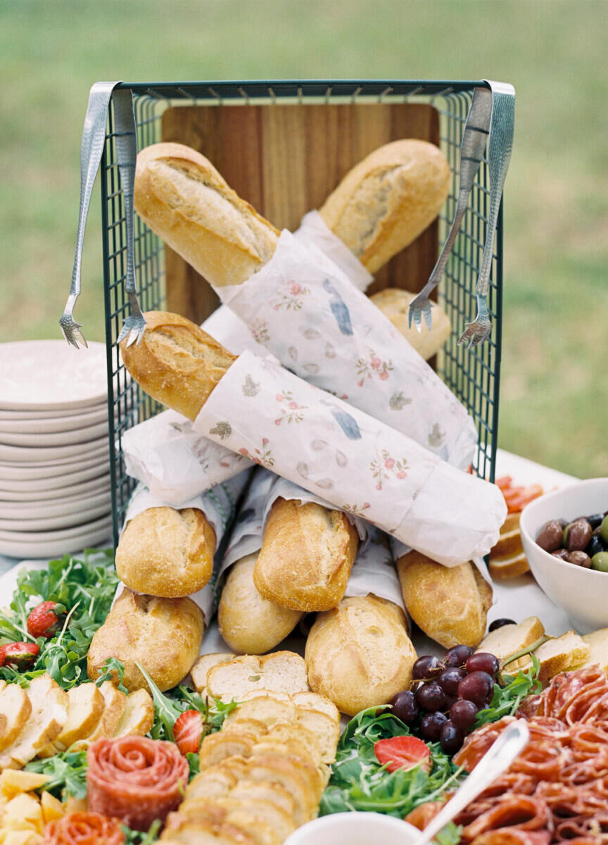 This elegant spring wedding's signature pattern of bespoke illustrations was printed on paper and wrapped around the baguettes on the grazing table.