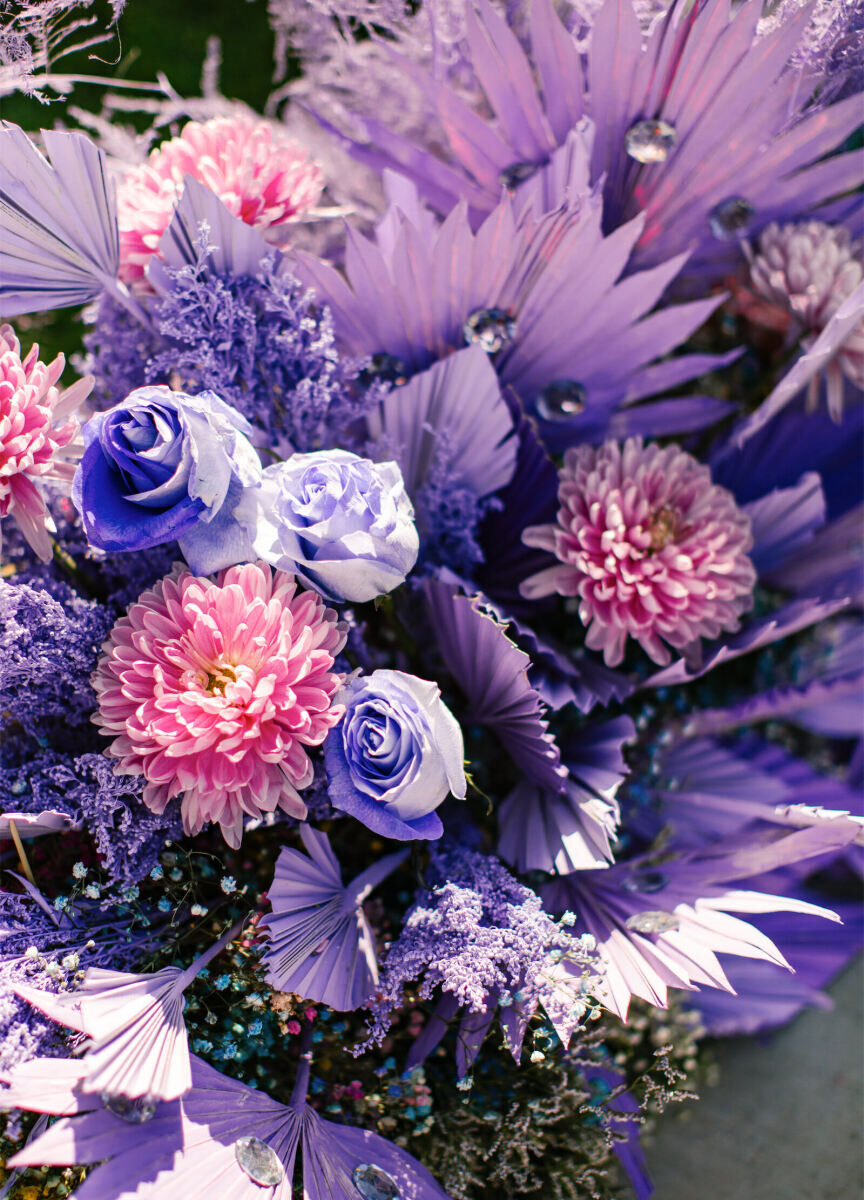 Some sections of the floral installation at a vibrant outdoor wedding were two-tone, like this purple and pink area, while others were a kaleidoscope of color.