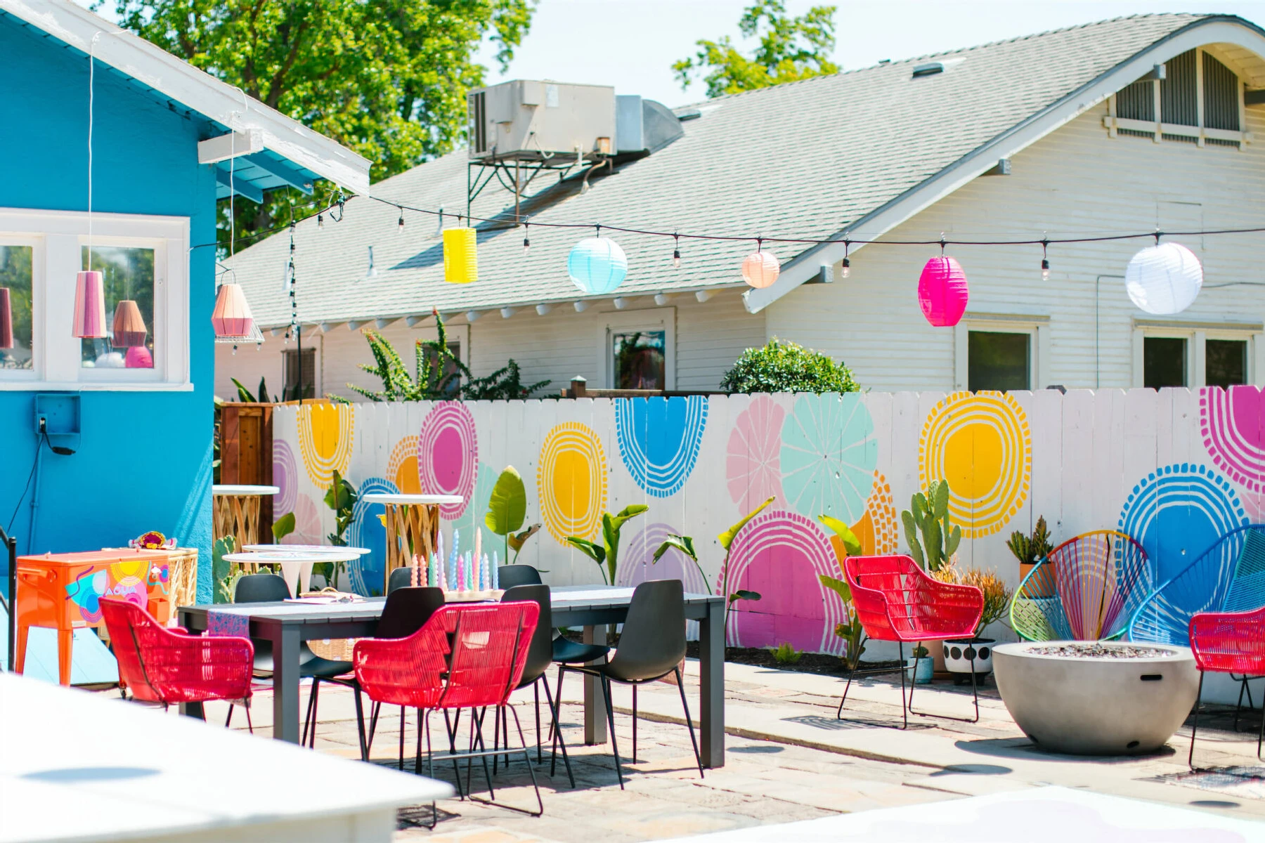 A mix of rental furniture was chosen for this vibrant, outdoor wedding to make it feel like the furniture in the couple's home had been brought outside.